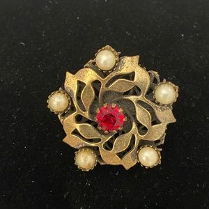 Vintage brass tone flower brooch with pearls and red rhinestone center